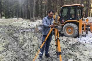 AEW surveyor with total station at a Himalayan project site